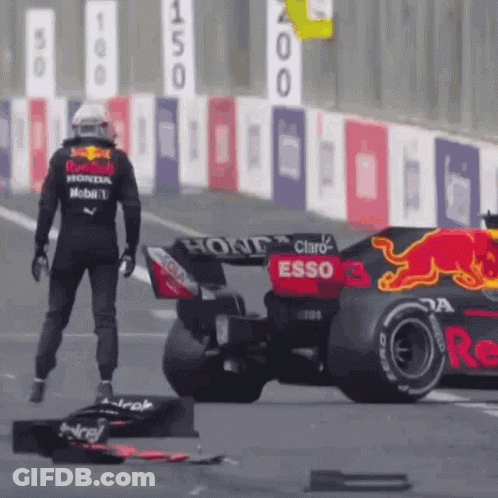Man Standing Next To Race Car On Track GIF