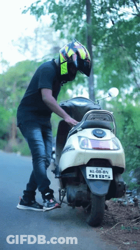 Man Standing Next To Scooter With License Plate KL DB BN 9185 GIF