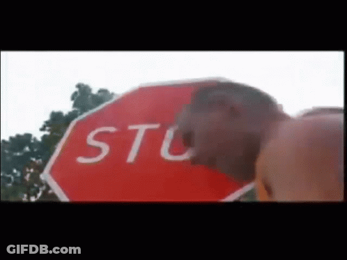 Man Standing Next To Stop Sign GIF