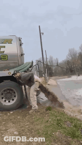 Man Standing Next To Tanker Truck With Number 9 GIF