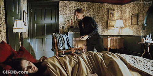 Man Standing Next To Woman Laying On Bed Rocktheholygrail GIF