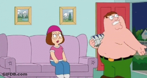 Man Standing Next To Woman Sitting On Couch GIF