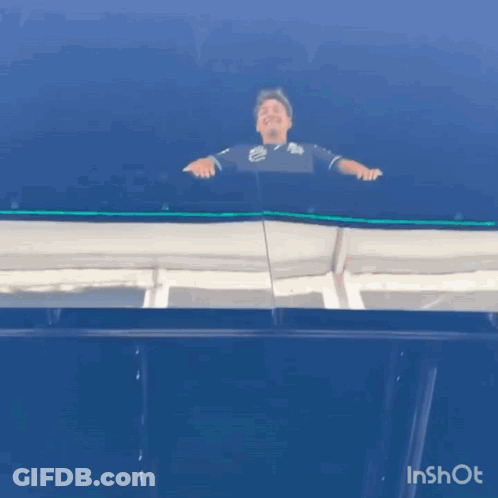 Man Standing On Balcony With Blue Sky GIF