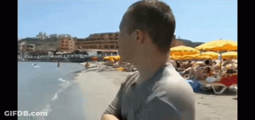 Man Standing On Beach Looking At Ocean GIF