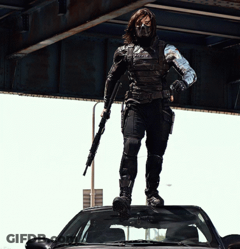 Man Standing On Car With Gun GIF