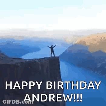 Man Standing On Cliff Overlooking Water GIF