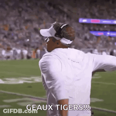 Man Standing On Football Field With Arms Outstretched Says Geaux Tigers GIF
