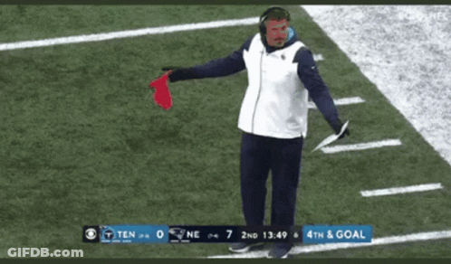 Man Standing On Football Field With Red Flag GIF