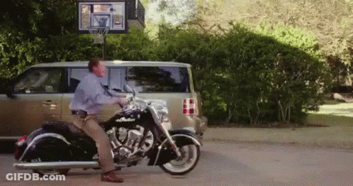 Man Standing On Motorcycle In Front Of Van GIF