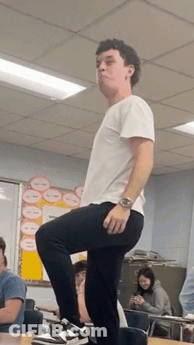 Man Standing On One Leg In Classroom GIF
