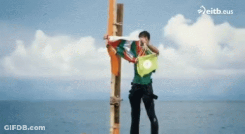 Man Standing On Pole In Ocean Eitb.eus GIF