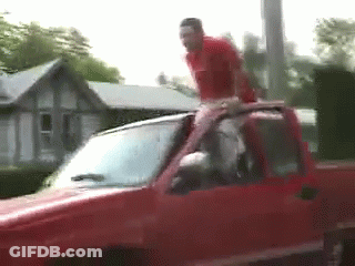 Man Standing On Red Truck Roof GIF