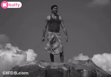 Man Standing On Rock Holding Knife With K Kulfy Logo GIF
