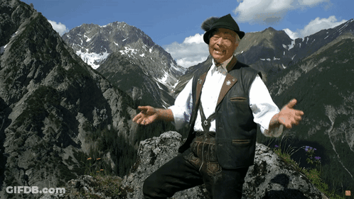 Man Standing On Rock In Mountain GIF