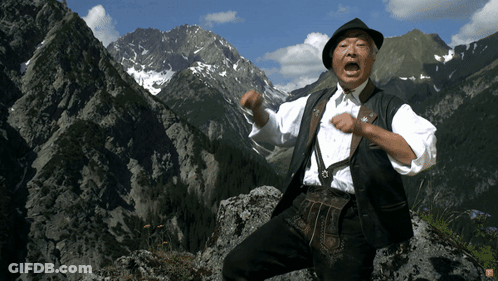 Man Standing On Rocky Mountain GIF