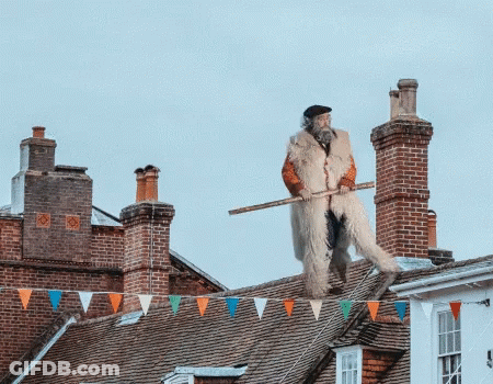 Man Standing On Roof With Stick GIF