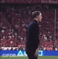 Man Standing On Soccer Field In Front Of Red Wood Sign GIF