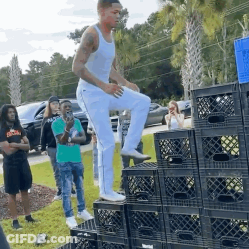 Man Standing On Stack Of Milk Crates GIF
