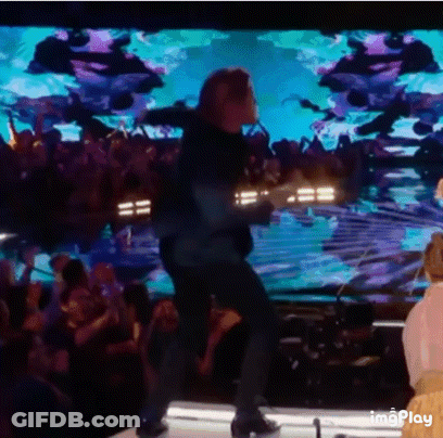 Man Standing On Stage In Front Of Crowd GIF