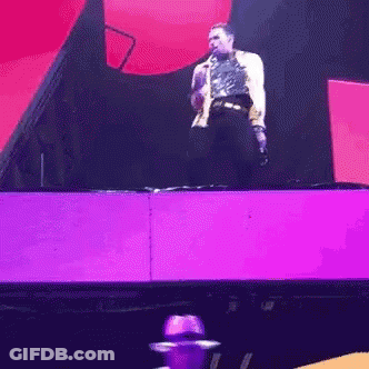 Man Standing On Stage With Microphone GIF