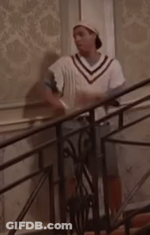 Man Standing On Stairs In Hat And White Sweater GIF