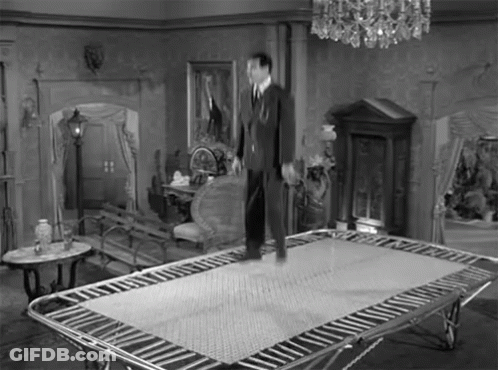 Man Standing On Trampoline Black And White GIF