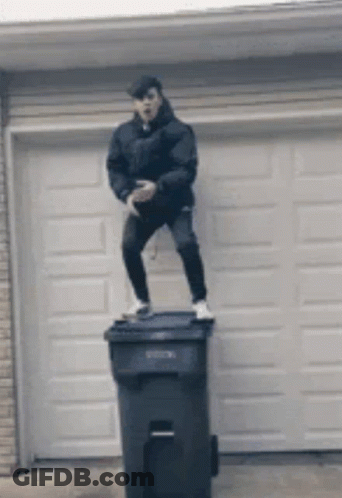 Man Standing On Trash Can In Front Of Garage Door GIF