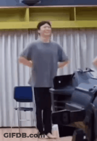 Man Standing With Hands On Hips Laughing GIF