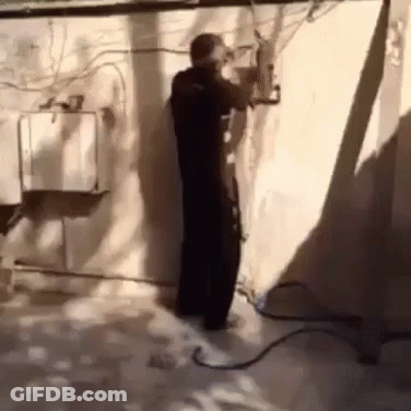 Man Standing With Hose Attached GIF