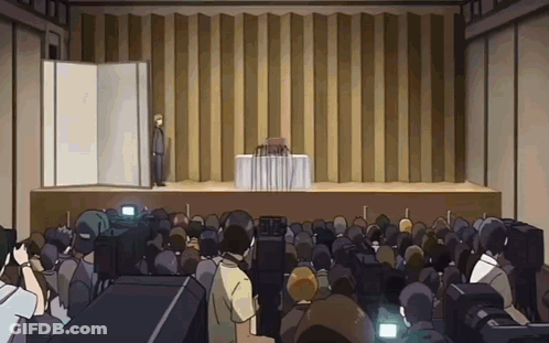 Man Stands On Stage In Front Of Large Crowd GIF