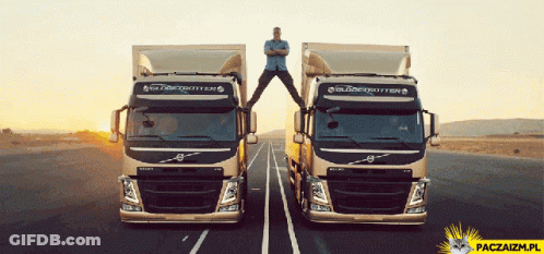 Man Stands On Top Of Two Volvo Trucks GIF