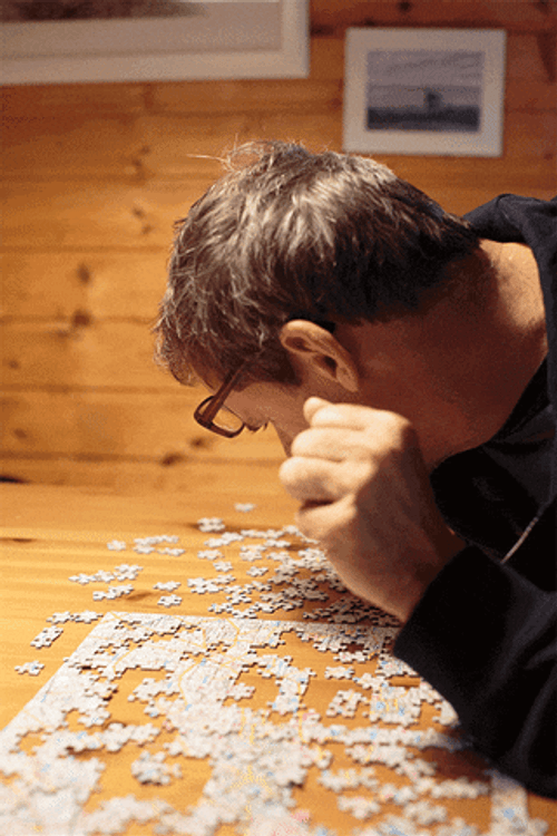 Man Staring At Jigsaw Puzzle GIF