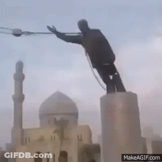Man Statue On Pedestal With Mosque Background GIF