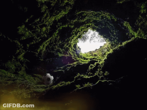 Man Statue Sitting At Table In Dark Cave GIF