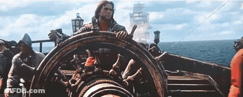 Man Steering Boat In Ocean GIF