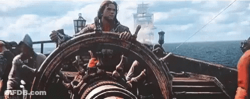 Man Steering Boat In Ocean GIF