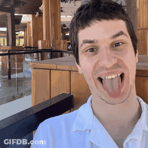 Man Sticking Tongue Out At Camera GIF