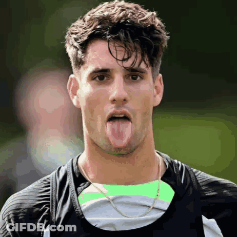 Man Sticking Tongue Out In Black Shirt GIF
