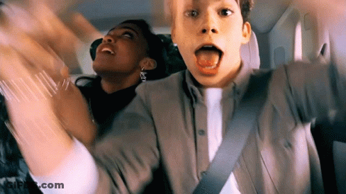 Man Sticking Tongue Out In Car Back Seat GIF