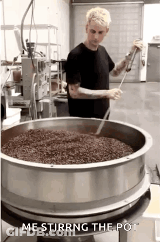 Man Stirring Food In Kitchen GIF