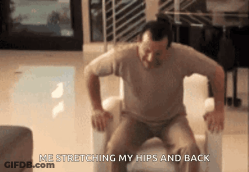 Man Stretching Hips And Back In Chair GIF