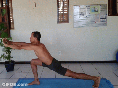 Man Stretching Legs On Blue Yoga Mat GIF