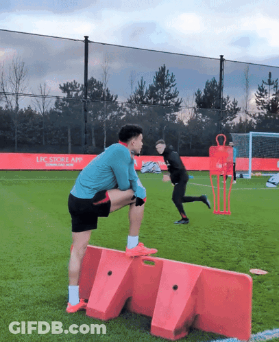 Man Stretching On Soccer Field With LFC App Ad GIF
