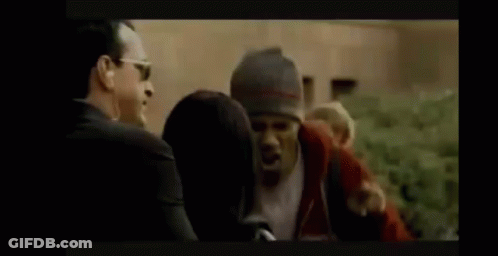 Man Suit Sunglasses Talk Woman Hat Man Watch GIF