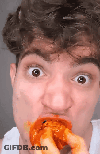 Man Surprised Eating Chicken Wing GIF