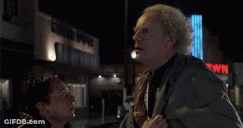 Man Surprised In Front Of Great Scott Sign GIF