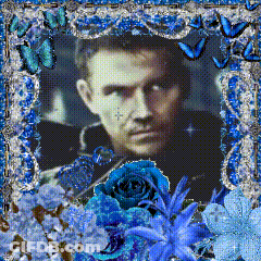Man Surrounded By Blue Flowers And Butterflies GIF
