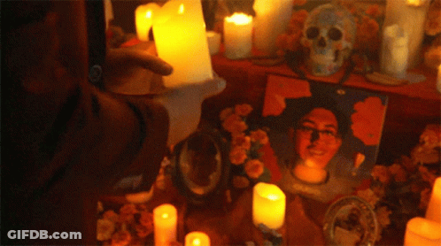 Man Surrounded By Candles And Skull GIF