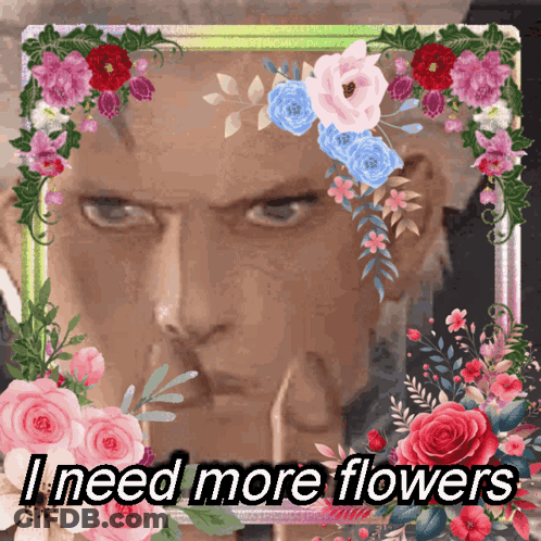 Man Surrounded By Flowers Saying I Need More Flowers GIF