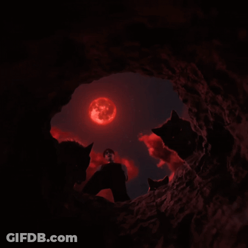 Man Surrounded By Three Black Wolves With Red Eyes GIF
